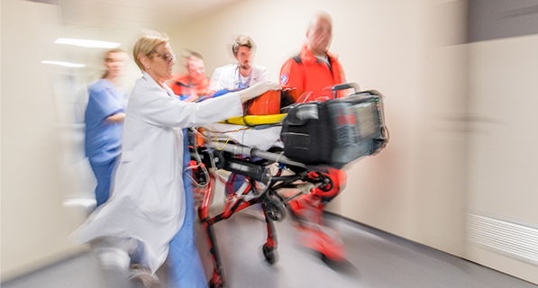 Doctors rushing patient to emergency room