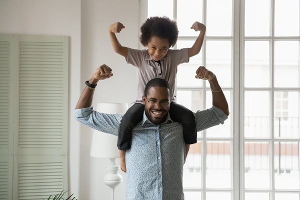 Father with son flexing muscles in fun stance