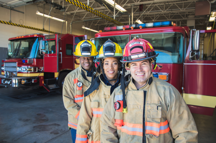 three Firefighters in  a firehouse